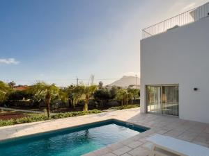 a swimming pool in the backyard of a house at GuestReady - A delightful stay in Porto Santo in Porto Santo