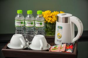 a table with bottles of water and cups and drinks at Golden Time Hostel 3 in Hanoi