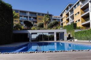 a swimming pool in front of a building at Condomínio Zen Pearl-Luxury com piscina in Funchal