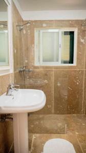 W łazience znajduje się umywalka, prysznic i lustro. w obiekcie Vila da Falésia-With Pool and views w Caniço