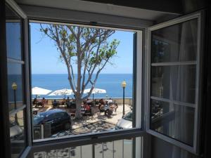フンシャルにあるBarreirinha II Perto da Cidade Velha Com Vista do Oceano de Niceの窓からビーチを望めます。
