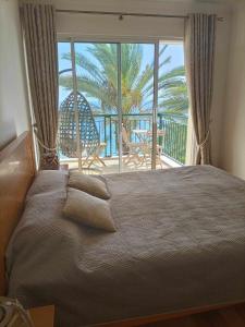 a bedroom with a large bed with a view of the ocean at GuestReady - Vila Formosa in Funchal