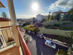 a balcony with cars parked in a parking lot at GuestReady - Nora Premium in Santa Luzia