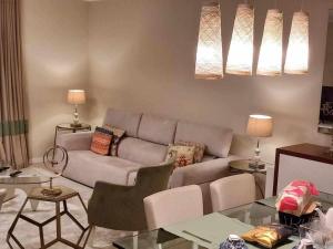 a living room with a couch and a table at GuestReady - Nora Premium in Santa Luzia