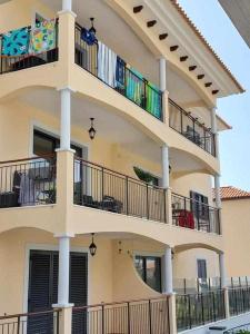a large building with balconies with towels on them at GuestReady - Nora Premium in Santa Luzia +38 photos