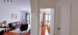 a living room with a couch and a table at Madeira - Sunset Sea View of Cabo Girão in Panasqueira