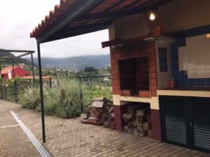 a model of a house with a fireplace in a yard at GuestReady - Casa Avó Alice in Porto da Cruz