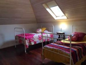 a bedroom with two bunk beds in a attic at GuestReady - Casa Avó Alice in Porto da Cruz