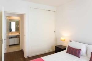 a bedroom with a bed and a bathroom with a mirror at Dolce Vita - City Center & Shopping Center in Funchal