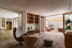 a living room with a chair and a table at tuuli in Nakatsu