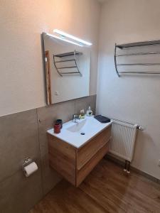 a bathroom with a sink and a mirror at Ferienhaus Finca de vida y luz in Auderath