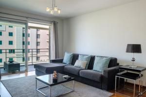 a living room with a couch and a table at GuestReady - Scenic Retreat with Seaview in Funchal