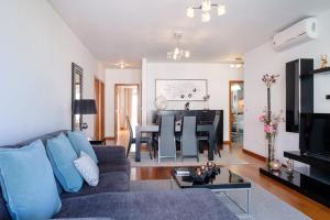 a living room with a couch and a table at GuestReady - Scenic Retreat with Seaview in Funchal