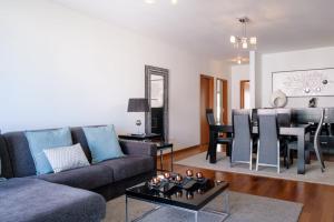a living room with a couch and a table at GuestReady - Scenic Retreat with Seaview in Funchal