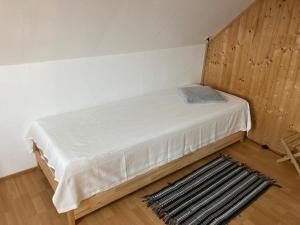 a small bedroom with a bed in a room at Ferienhaus Rennsteigblick in Eisfeld