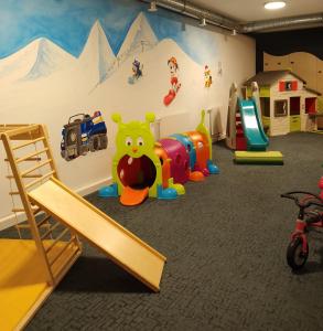 a play room with many different types of play equipment at Appartement & Suiten Hotel Glöcknerin in Obertauern