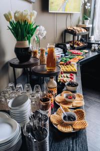 a buffet of food on a table with plates at Brim Hotel in Reykjavík