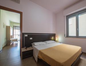 Postel nebo postele na pokoji v ubytování Residence Palazzo Gasparroni