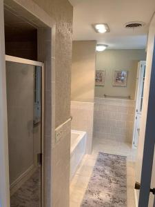 a bathroom with a shower and a tub and a sink at Charming Retreat in heart of Amarillo in Amarillo