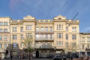 a large building on the corner of a street at InshiApartments on Slovatskoho str in Lviv