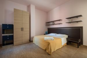 Postel nebo postele na pokoji v ubytování Residence Palazzo Gasparroni