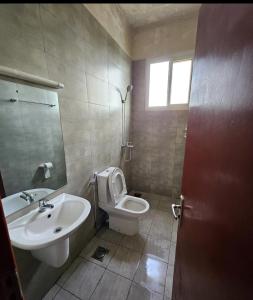 a bathroom with a toilet and a sink at Zanzibar Homestay in Kiembi Samaki