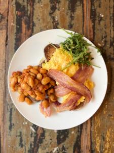 a plate of breakfast food with bacon eggs and beans at East Quay in Watchet