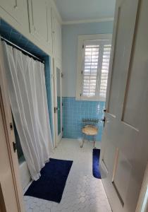 a bathroom with a window and a blue tiled floor at Fairfax Bed and Breakfast in Franklin