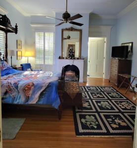 a bedroom with a bed and a mirror on the wall at Fairfax Bed and Breakfast in Franklin