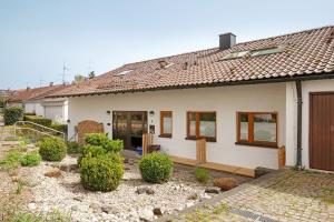 a white house with a garden in front of it at Blaustein Loft in Blaustein