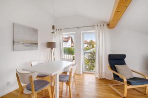 a dining room with a white table and chairs at Blaustein Loft in Blaustein