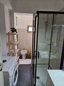a bathroom with a shower and a toilet and a sink at Palazzina al Lingotto in Turin