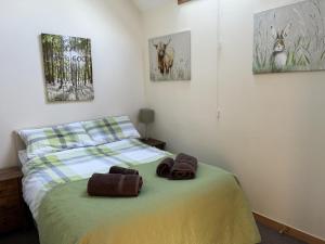 a bedroom with a bed with two towels on it at Broomhead Cottages in Dufftown