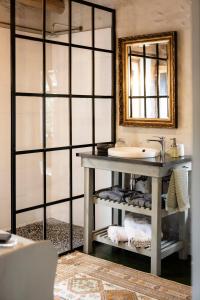 a bathroom with a sink and a mirror at Olive Stone Farm Cottages in Montagu