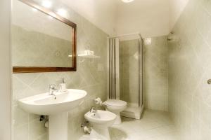 a bathroom with a sink and a toilet and a shower at B&B Antica Dimora in Olbia