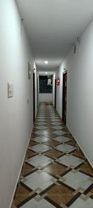 a hallway with a tile floor in a building at PRIME RESIDENCY in Pedda Ambarpet