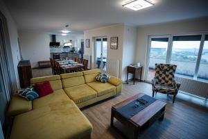 a living room with a couch and a table at Olive Garden Apartment in Plovanija