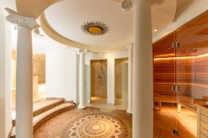 a staircase in a house with columns and a ceiling at Appartement & Suiten Hotel Glöcknerin in Obertauern