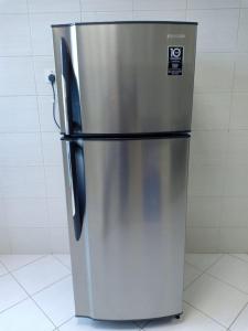 a stainless steel refrigerator sitting in a kitchen at 22 R3 Luxury Room in a 4-bedroom apartment with private washroom outside the room ### 22 R3 غرفة فاخرة في شقة 4 غرف نوم مع حمام خاص خارج الغرفة ### in Ajman 