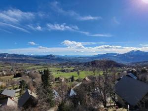 an aerial view of a village with mountains in the distance at Studio Saint-Michel-de-Chaillol, 1 pièce, 2 personnes - FR-1-393-20 in Saint-Michel-de-Chaillol