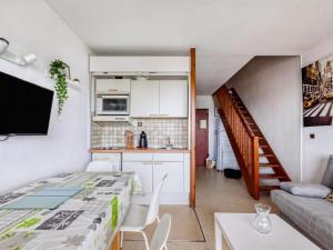 a kitchen and a living room with a table and chairs at Appartement Hendaye, 2 pièces, 5 personnes - FR-1-2-390 in Hendaye