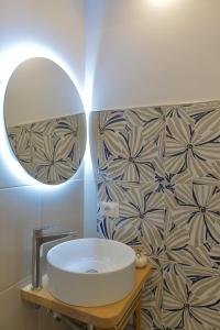a bathroom with a white sink and a mirror at Charming Rooms Amalfi Coast in Maiori