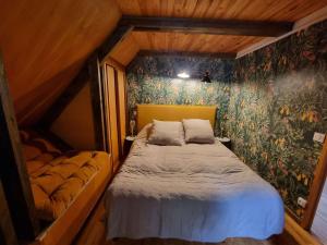 a small bedroom with a bed and a wall mural at Chalet Saint-Michel-de-Chaillol, 4 pièces, 6 personnes - FR-1-393-159 in Saint-Michel-de-Chaillol