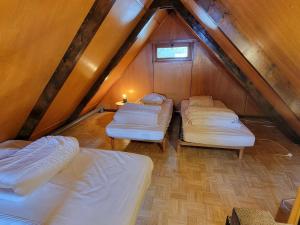 a room with four beds in a attic at Chalet Saint-Michel-de-Chaillol, 3 pièces, 5 personnes - FR-1-393-165 in Saint-Michel-de-Chaillol
