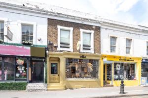 a row of stores on a city street at 3 bedroom house in Notting Hill in London