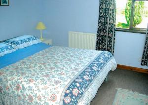 A bed or beds in a room at Wayside Lodges 