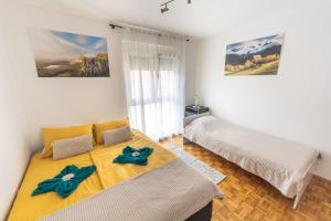 a bedroom with two beds and a window at Apartment Vita in Izola