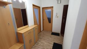 a room with a dresser with a mirror and some doors at Apartmán Mikaela 68 m2 in Poprad