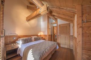 a bedroom with a large bed and wooden walls at Savoielac - La Clusaz - Centre du village : Appartement Clusaz Coeur in La Clusaz