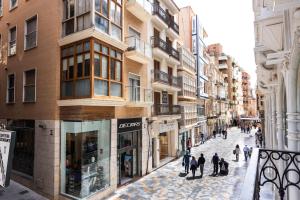 a group of people walking down a street at Apartamentos Turísticos Puerto Cartago by CartagenaSpain in Cartagena